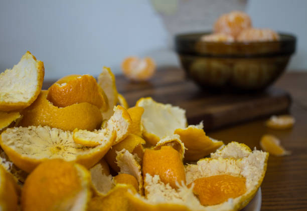 istock Peeled tangerines and peel on a plate on the table 1192525351