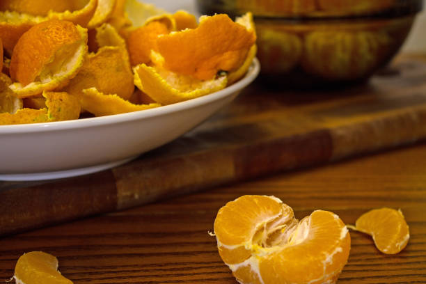 istock Peeled tangerines and peel on a plate on the table 1192525352