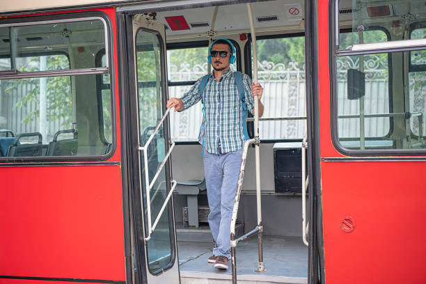 istock Young Man with Headphones is Exiting the Bus 1192525701