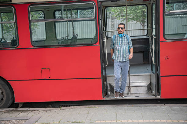 istock Young Man with Headphones is Exiting the Bus 1192525897