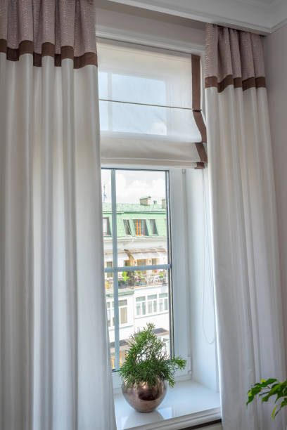 istock Curtains in the interior. From natural light linen, with decorative braid In the room, 1192530474