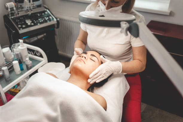 istock Cosmetologist massages the client's face 1192530523