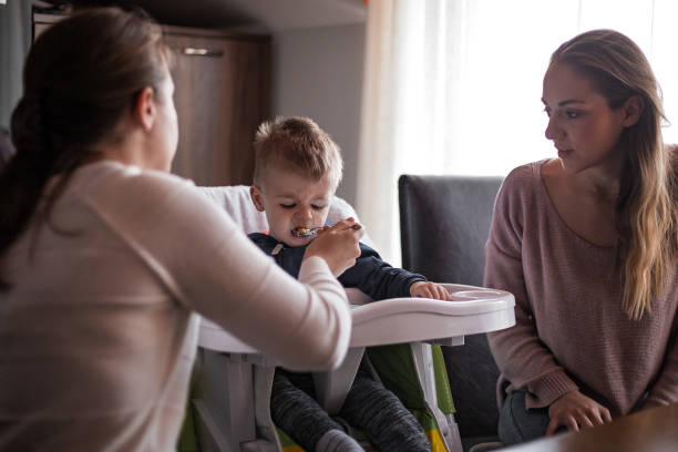 istock Mother spoon feeding her baby 1192531561