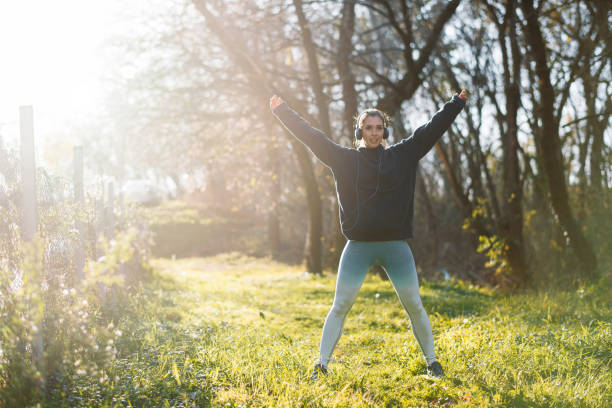 istock Young woman runner stretching outdoors 1192535627
