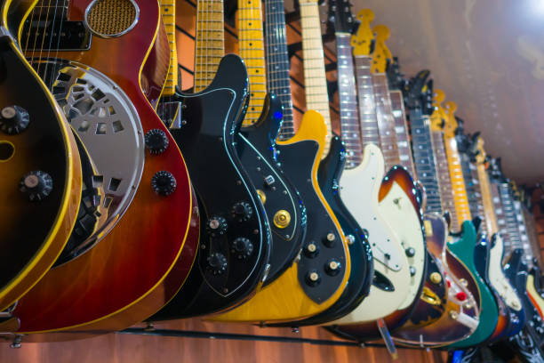 Music shop interior and large collection of classic acoustics guitars for sale.
