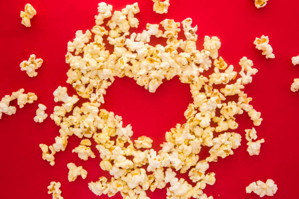 istock Cinema party concept. Love pop corn in a red background. Flat lay. 1192539188