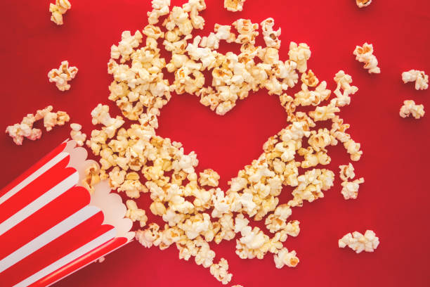 istock Cinema party concept. Love pop corn in a red background. Flat lay. 1192539213