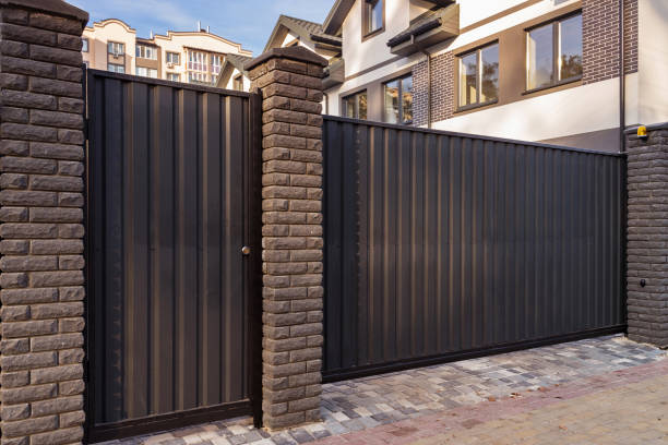 istock Automatic metal gates with decorative brick columns on the street side. 1192540066