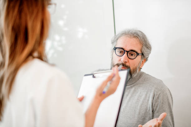 istock Senior man discusses diagnosis with doctor 1192540428