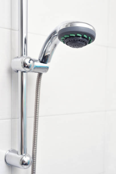 istock Close-up shower in the holder on a white tiled wall 1192544248