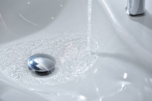 istock Water flows into a new white sink in the bathroom 1192544372