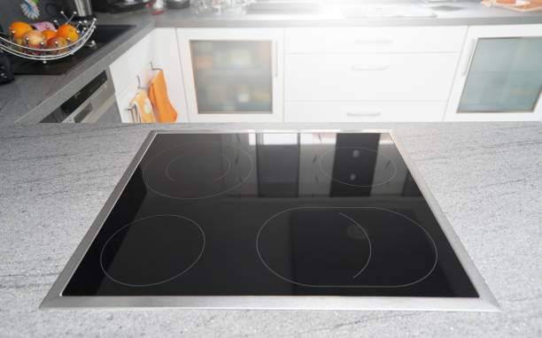 istock Built-in induction cooker with a black glass surface in the kitchen 1192544553