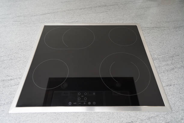 istock Built-in induction cooker with a black glass surface in the kitchen 1192544614