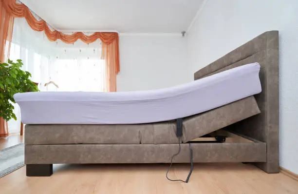 Photo of Bed with tilt adjustment mattress bed in the bedroom of the house, comfortable mattress and sleep