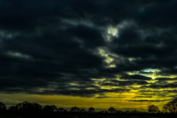 Dark clouds with yellow sky