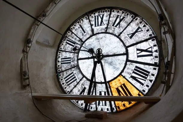 Large clock-face of old mechanical clocks on a tower in a church, inside view