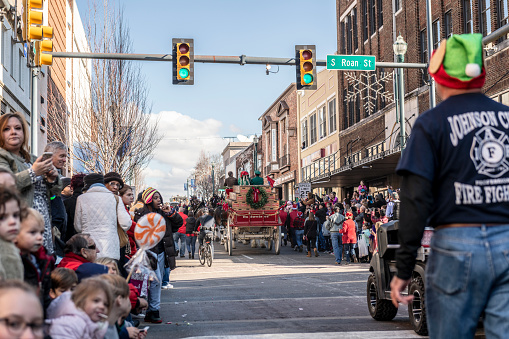 Johnson City, Tennessee, USA - December 7, 2019: The horse-drawn Budweiser beer wagon, pulled by six Clydesdales, rolls down Main Street during the annual Christmas parade in Johnson City, Tennessee.