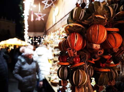 Orange garland decorations hanging on a Christmas market stall - Vienna.