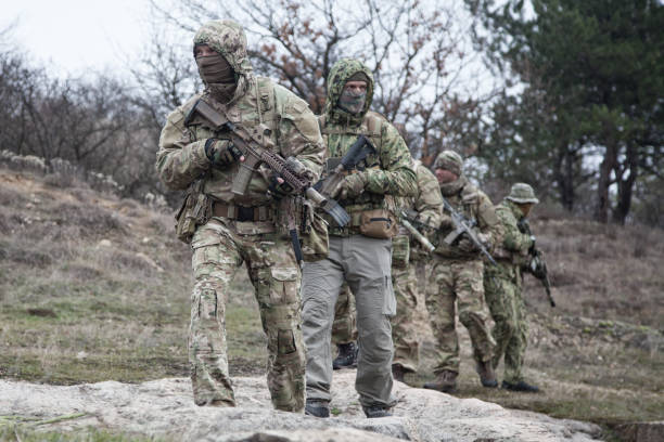 istock Military army soldiers team patrolling in forest 1192563408