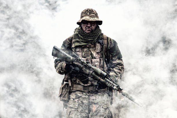 istock Brutal commando veteran army soldier armed sniper rifle 1192563410