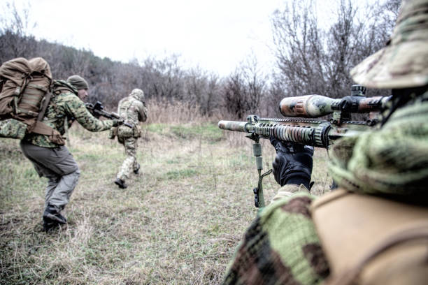 istock Commando army soldiers fighters squad rushing in woodland 1192563477