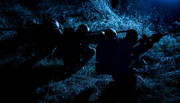 istock Army tactical group fighters sneaking in darkness 1192563510
