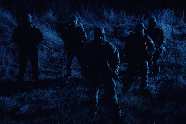 istock Army soldiers crew patrolling territory at night 1192563521