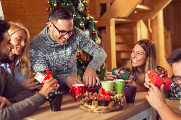 istock Friends exchanging Christmas presents 1192565487