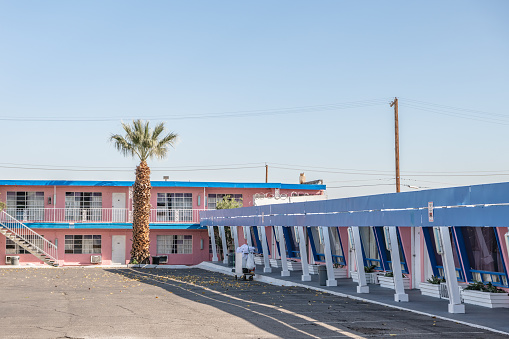 Two young women taking pic's at Roy's Motel in Amboy, California. The photo was taken April 20th 2023 in Amboy, USA at historic route 66.