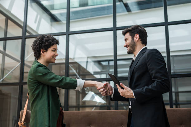 istock Business couple shaking hands 1192566681