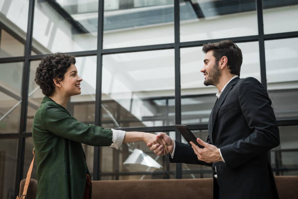istock Business couple shaking hands 1192566683