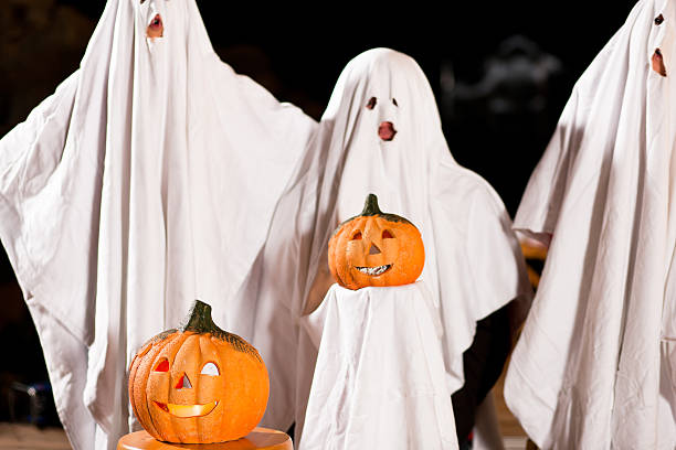 istock spooks at Halloween - focus on pumpkin 119256704
