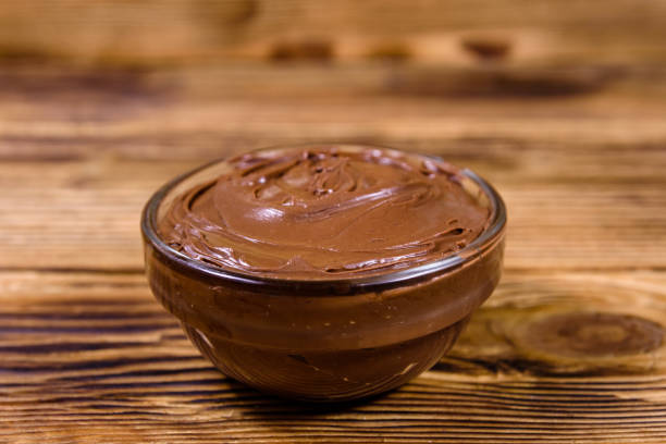 istock Glass bowl with chocolate spread on a wooden table 1192567912