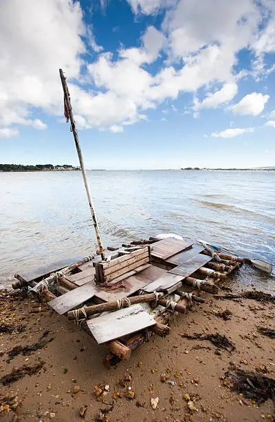 Old discarded wooden raft washed up on a beach on Brownsea Island Poole Harbour, South coast of England