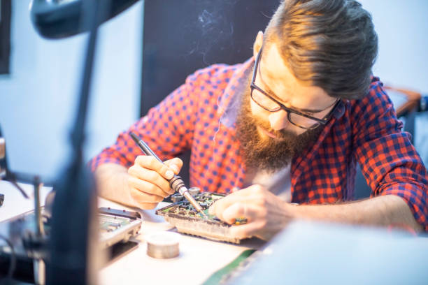 istock Young man mechanic doing car chip tuning 1192573800