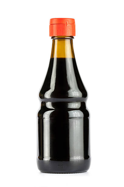 A bottle of soy sauce with orange screw on lid and no label Glass bottle of soy sauce  soy sauce photos stock pictures, royalty-free photos & images