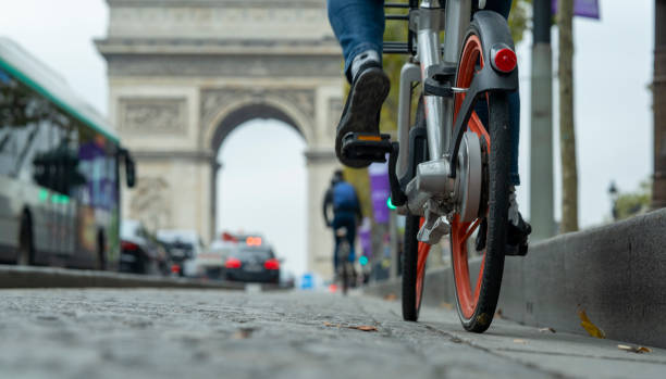 Tour Paris by bike with Arc de Triomphe in the background stock photo