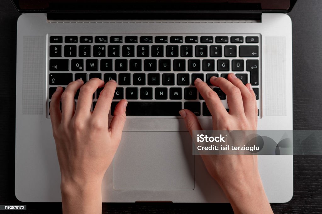 Closeup of woman hand typing on laptop keyboard Technological concept Hand Stock Photo
