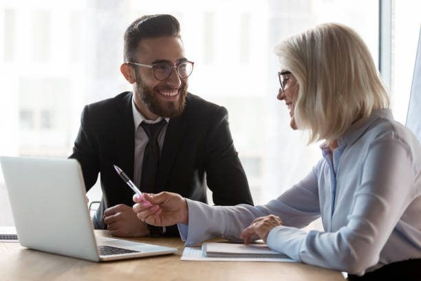 istock Smiling diverse businesspeople talk discussing ideas on laptop 1192578962