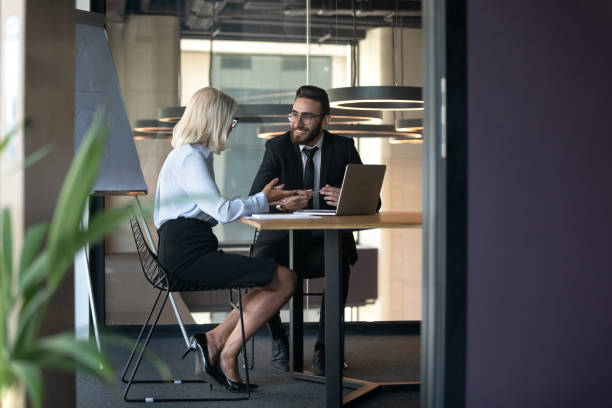 istock Smiling multiethnic colleagues discuss ideas in office together 1192578967