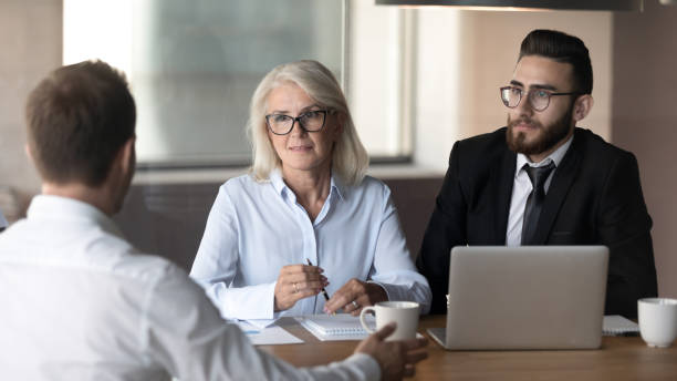istock Multiethnic recruiters consider job applicant at interview 1192578984