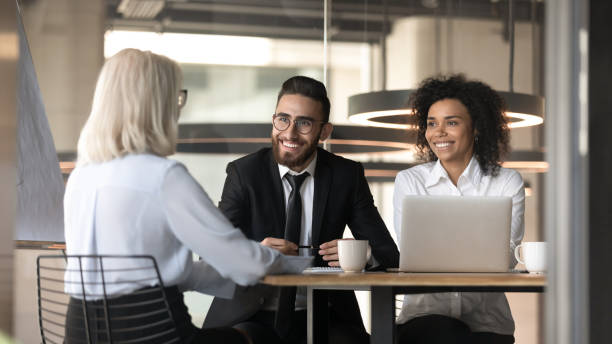 istock Smiling multiracial employers impressed by female applicant at interview 1192578995