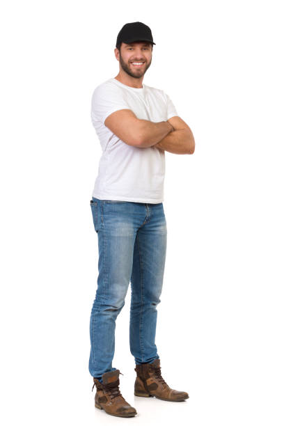 uśmiechnięty przypadkowy mężczyzna czarna czapka stoi z skrzyżowanymi ramionami - t shirt white men jeans zdjęcia i obrazy z banku zdjęć