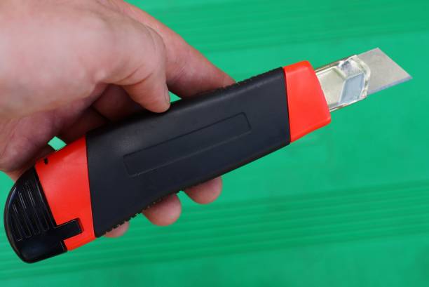 istock hand holds a one stationery knife with a blade 1192580829