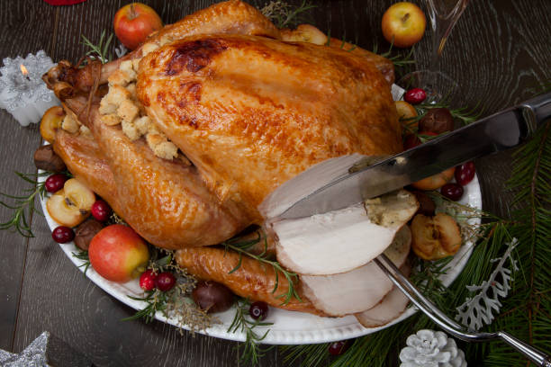istock Carving Roasted Christmas Turkey with Grab Apples 1192581476