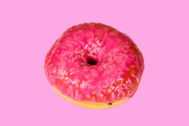istock Donut with glazed top isolated on a pink background 1192584362