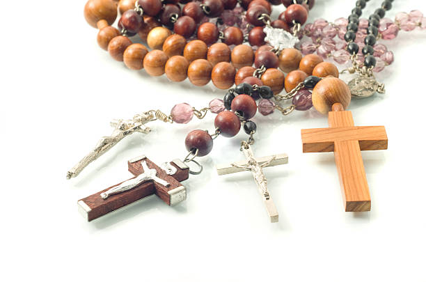 istock Rosary beads over white with focus on crosses 119258559