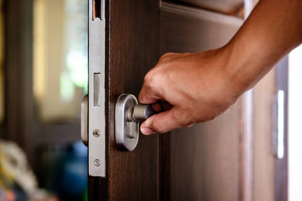 istock Hand locking the wooden door 1192586396