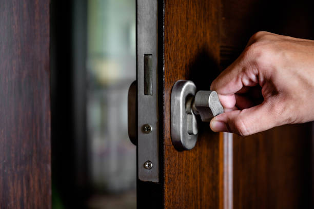 istock Hand locking the wooden door 1192586410