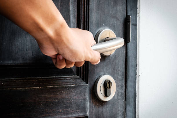 istock Hand opening a wooden door 1192586596